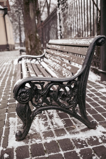 A bench with the word " on it's arm. "