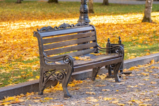 A bench with the word on it's side sits in the grass