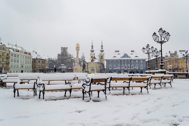 Benches covered in snow.