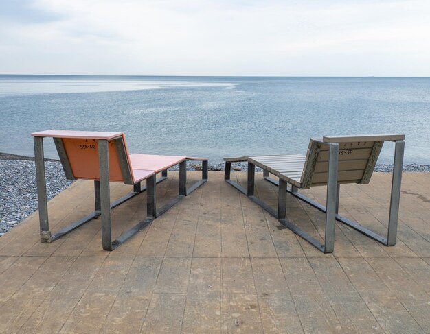 Benches for lying by the sea Sun loungers in the park against the background of the sea Benches in the park in the southern resort