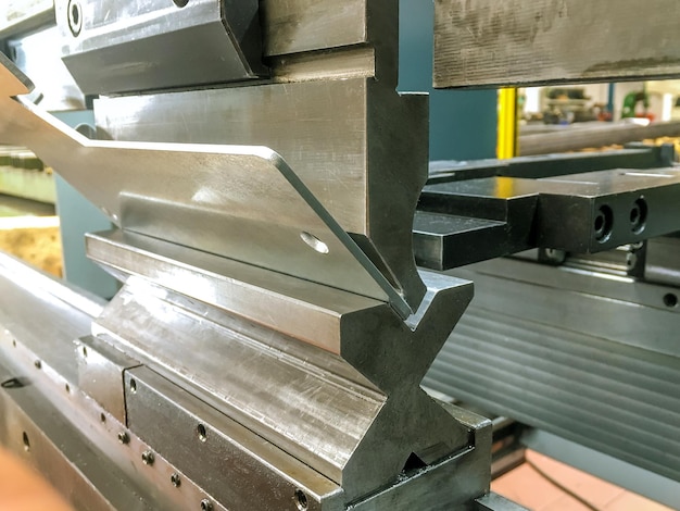 Bending sheet metal with a hydraulic bending machine at the factory.