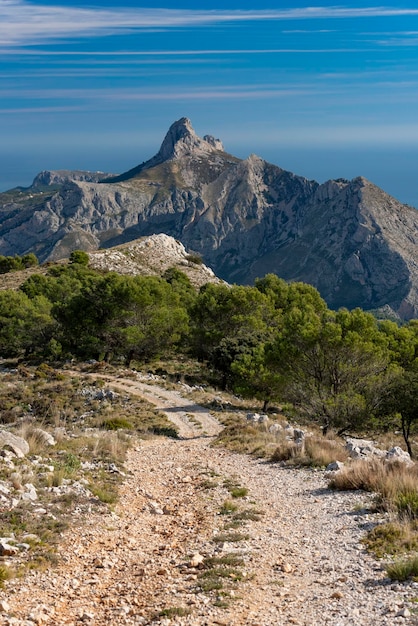 Bernia Mountain 1128 msn and empty dirt road Alicante province Costa Blanca Spain