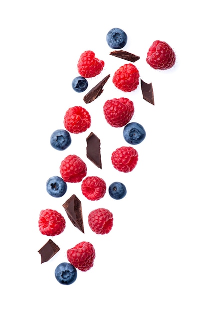 Berries are flying in the air. Raspberry and blueberries  with chocolate chip on white backgrounds.