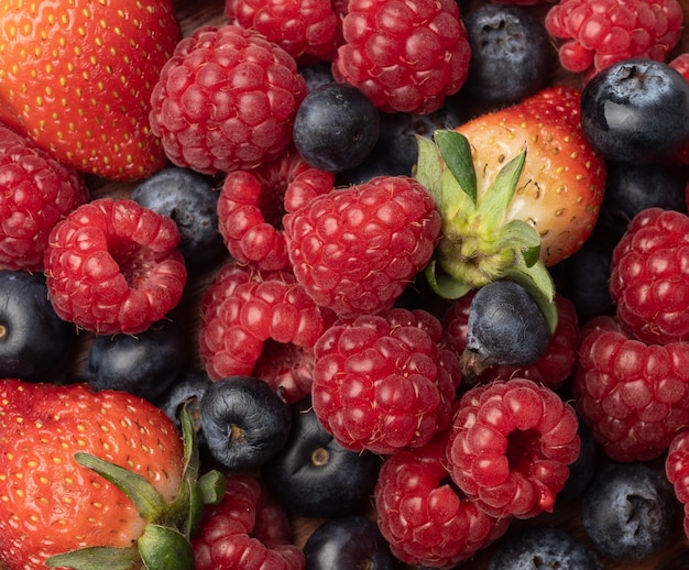 Berries closeup backdrop. Strawberry, raspberry and bluberry.