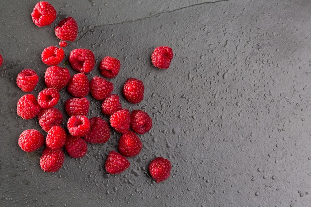 berries raspberry on black slate background