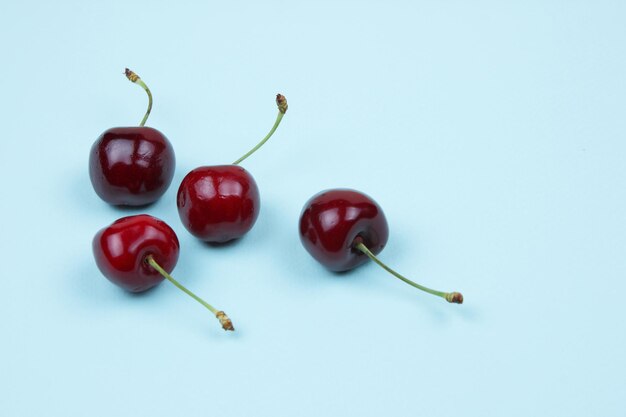 Berries of red sweet juicy cherries on a blue background Closeup of sweet berries View from above