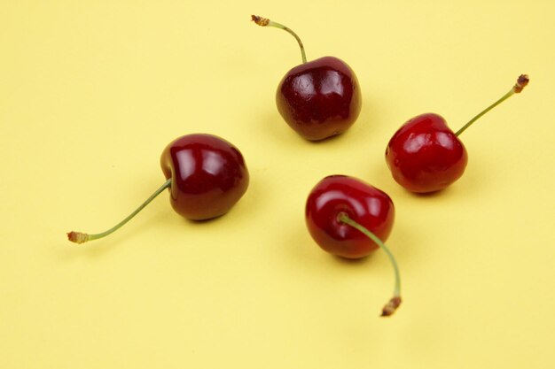 Berries of red sweet juicy cherries on a yellow background Closeup of sweet berries View from above