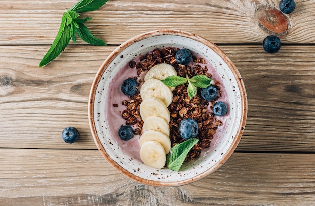 Berry banana smoothie bowl with chocolate granola blueberries and mint healthy food