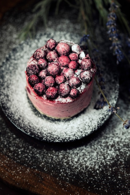 Berry cake with lavender on the wood table.