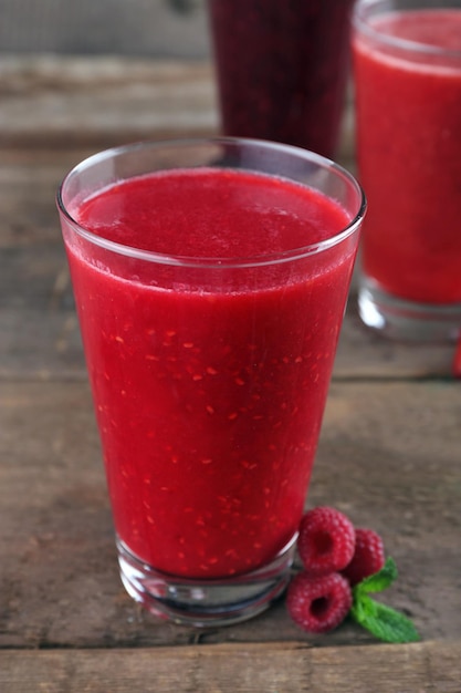 Berry cocktails and fresh berries on wooden background