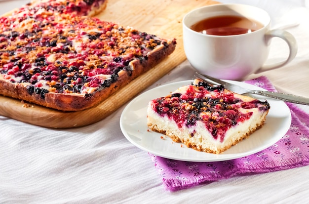 Berry pie with cottage cheese on wooden cutting board