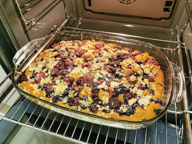 Berry pie with crumbs in the oven Baking with currants and strawberries