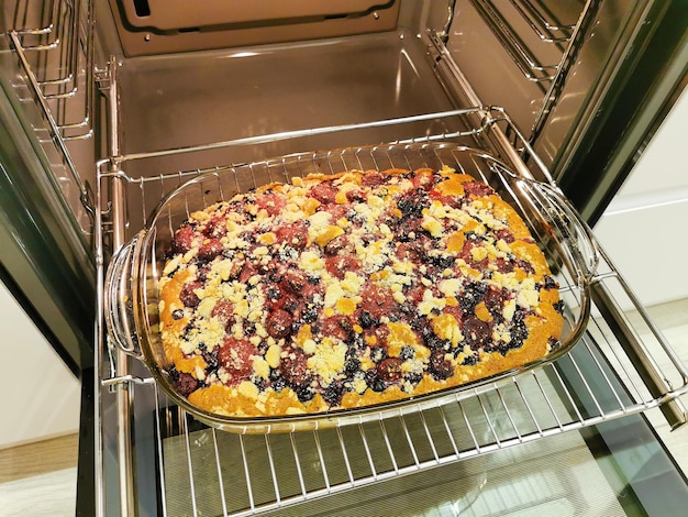 Berry pie with crumbs in the oven Baking with currants and strawberries