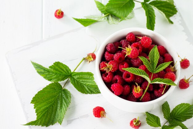 Berry raspberries on the kitchen wooden table Fruit dessert and healthy dieting