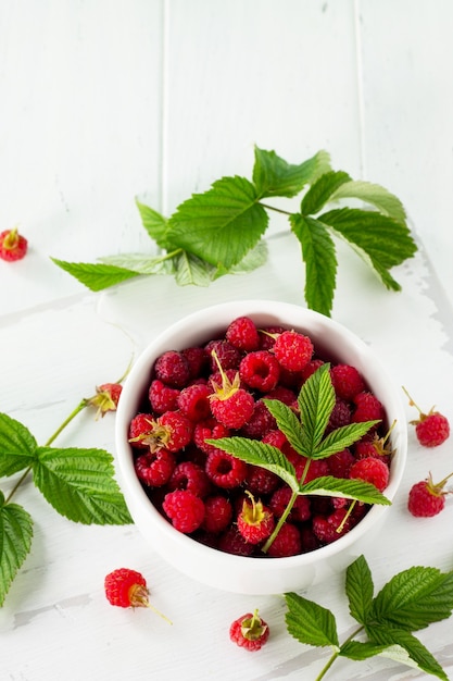 Berry raspberries on the kitchen wooden table Fruit dessert and healthy dieting