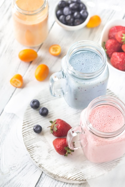 Berry smoothies on the wooden board