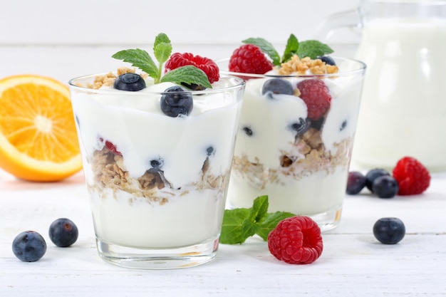 Berry yogurt yoghurt with berries fruits cup muesli wooden board breakfast