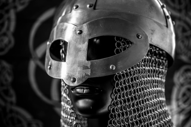 Berserker helmet of viking warrior with mail on coat of arms with drawings and viking symbolism traditional art of northern Europe conflict struggle and war