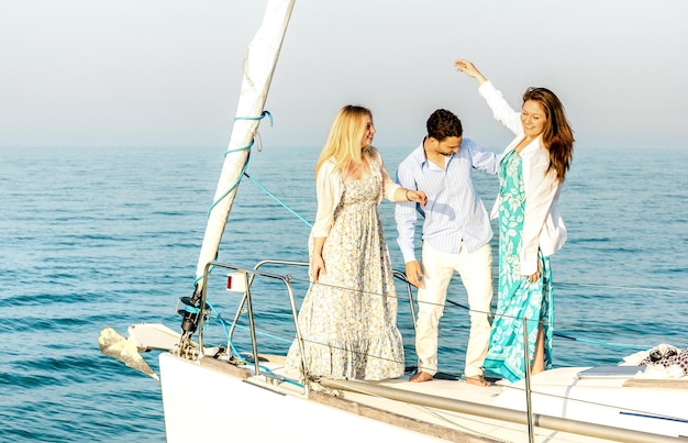 Best friends dancing and having fun on exclusive luxury sailing boat