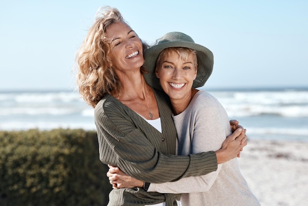 Best friends for life Cropped shot of two attractive mature women hugging while standing on the beach