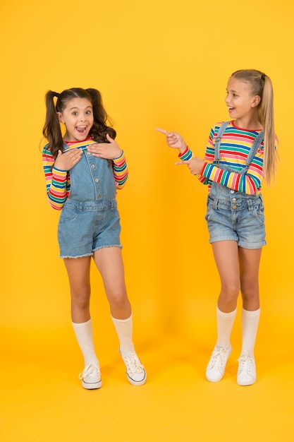 Best friends Trendy and fancy Emotional kids Fashion shop Modern fashion Kids fashion Little girls wearing rainbow clothes Happiness Girls long hair Cute children same outfits communicating