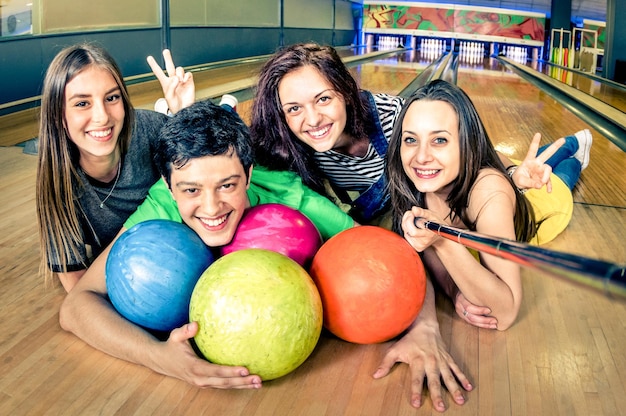 Best friends using selfie stick taking pic on bowling track