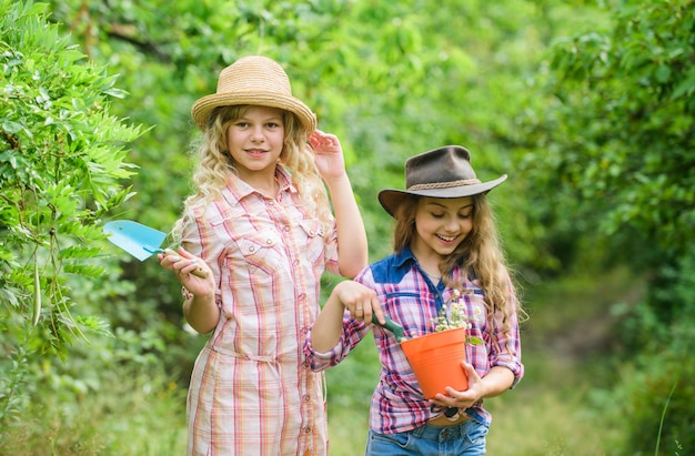 The best job ever. happy farming. spring country side. earth day. summer family farm. protect nature. Rich harvest. children work using gardening tool. small girls farmer in village. Beauty of nature.