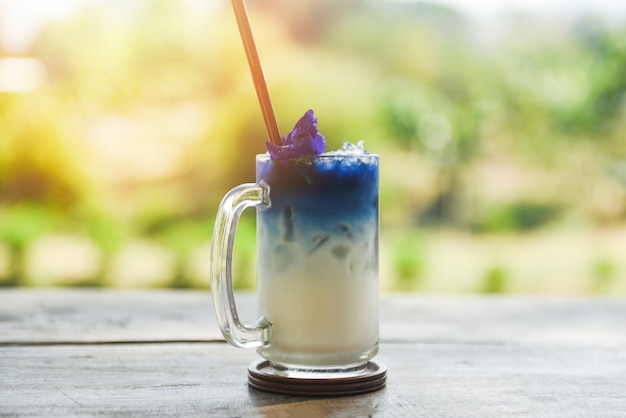 Beverage of butterfly pea drink glass on wooden table