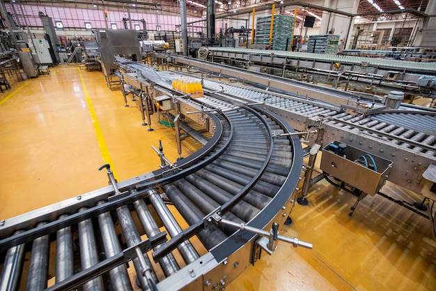 Beverage factory interior Conveyor flowing with bottles for juice