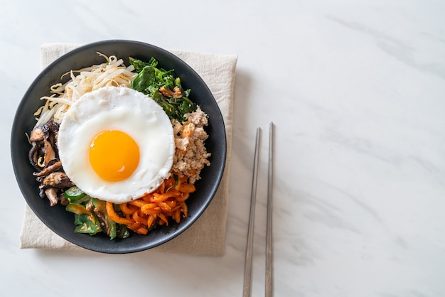 Bibimbap, Korean spicy salad with rice and fried egg - traditionally Korean food style