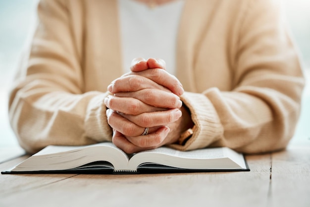 Bible praying or hands of woman in prayer reading book for holy worship support or hope in Christianity or faith Jesus Christ zoom or elderly person studying or learning God in spiritual religion