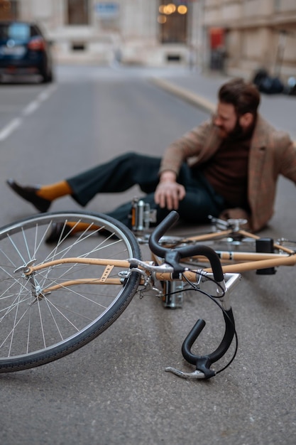 Bicycle accident in city Man cyclist fell off road bike while cycling Bike injurie injured knee