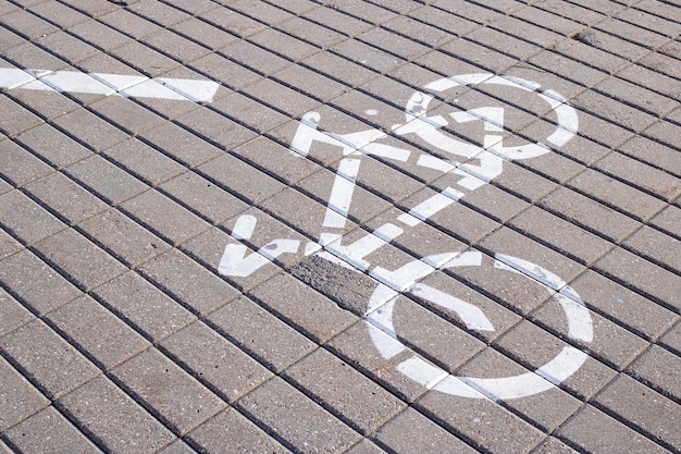 Bicycle path sign painted on paving slabs