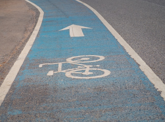 Bicycle symbol on asphalt bike lane.