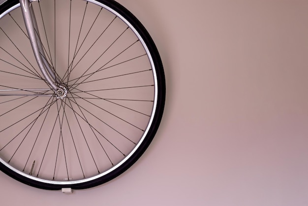 Bicycle wheel hanging on the wall with copy space Wall mounted bike storage in the apartment