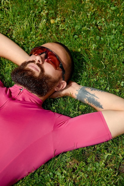 Bicyclist taking rest in the green grasses Summer time great mood