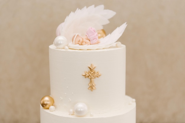 A big beautiful pink and white cake for a baby for baptism