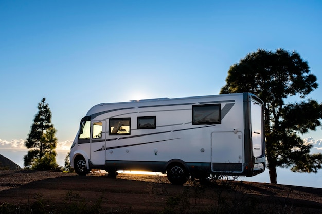 Big camper motorhome parked in off road nature space to enjoy total freedom. Off grid lifestyle vanlife. Travel with camping car and discover the beauty of the world