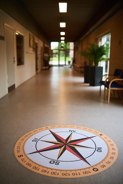 A big compass painting on the floor in a school