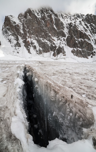 Big crack in ice near mountains