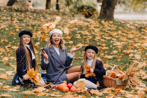 A big family on a picnic in the fall in a nature park Happy people in the autumn park