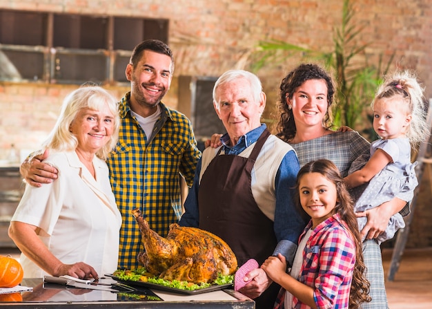 Big family standing near roasted ham