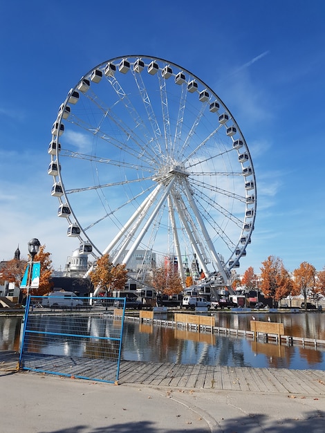 big ferris wheel with autumn trees around