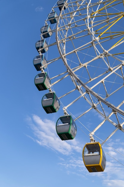 Big ferris with cabins wheel against deep blue sky part of of giant wheel in amusement park