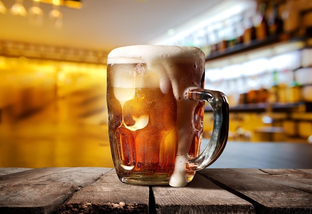 A big glass of beer on counter bar in restaurant