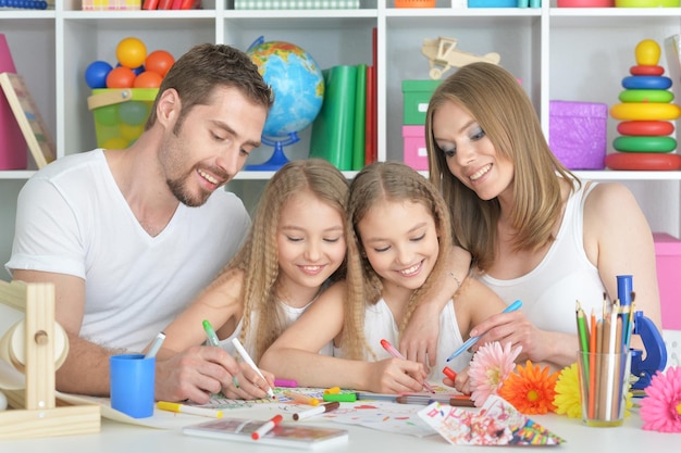 Big happy family drawing together at kids room