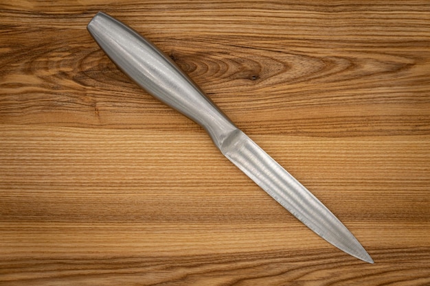 Big kitchen knife lying on a cutting board gray kitchen knife Steel kitchen chef's knife