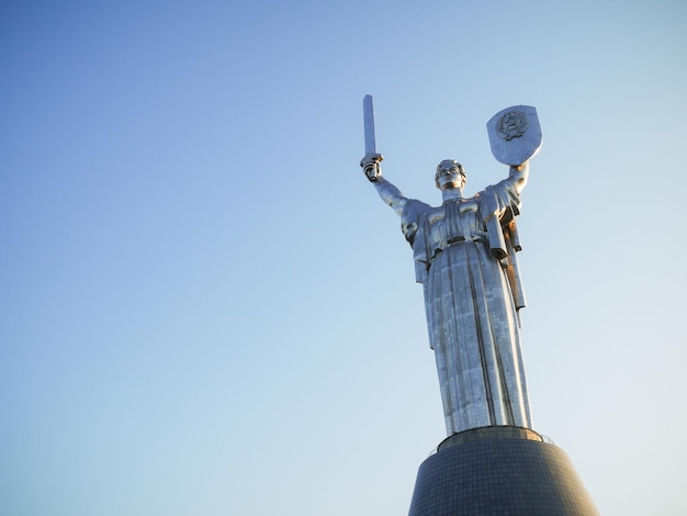 Big metal statue motherland monument towering to the skies with no background kiev ukraine