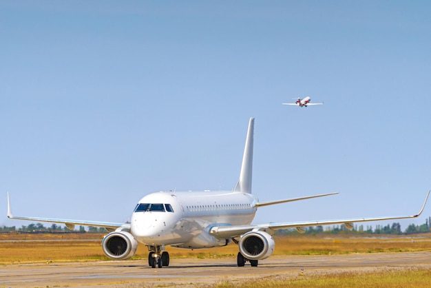 Big passenger airplane drives along the runway in airport