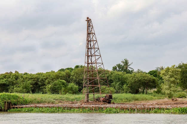 The big Pile hammer machine on the river for build dam